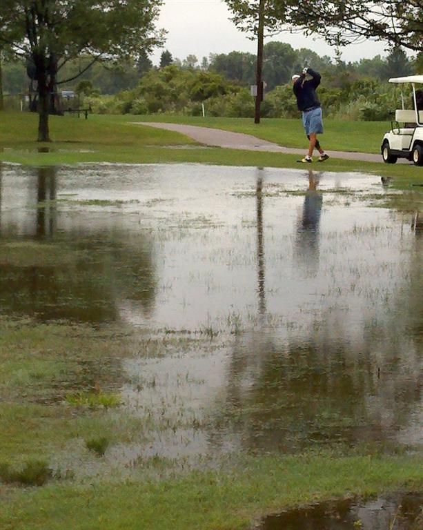  Glenn McKenzie hits over what looks like a water hazard, but is actually casual water due to some horrible storms that went through Sunday morning.&nbsp;  